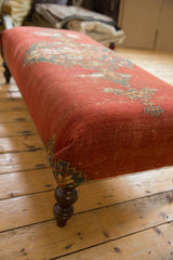 Finely woven antique Malayer rug fragment in rust, blue, and green, on a turned wooden leg.
