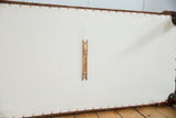 Antique rug ottoman underside: cotton canvas, copper studs, Old New House brand tag.