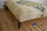 Antique Persian Ottoman corner: aged ivory Doroksh fragment, dusty navy design, turned leg.
