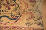 Close-up of antique Kerman rug fragment with curvilinear dragon, cochineal red, navy.