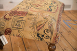Antique Persian Kerman rug fragment, showcasing aged ivory, red, and charcoal lantern and dragon motifs.