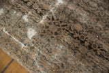 Distressed texture of the vintage Persian rug fragment, with worn areas and foundation visible.