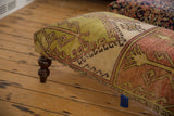 Vintage Oushak Rug Ottoman Table with dark turned leg, cotton canvas, and brass studs.