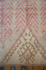 Mid-century vintage Oushak rug fragment with distressed blush, tan, and ivory patterns.