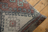 Textured distressed vintage Turkish rug fragment, with time-softened rust, gray, and cream patterns.