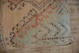 Muted sage, beige, and terracotta pattern on a distressed Turkish Oushak fragment.