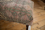Distressed vintage Oushak rug fragment with faded turquoise and lavender geometric pattern.
