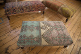 Vintage Oushak ottoman end with distressed faded turquoise, lavender, and ivory geometric patterns.