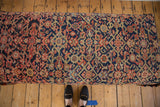 Intricate geometric-floral design on vintage Persian rug fragment, in navy, blush, and ivory.
