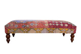 Vintage Oushak rug fragment ottoman table, geometric patchwork in purple, red, golden yellow, mint.
