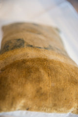 Textured surface of the antique Chinese rug fragment pillow with subtle time-softened hues.