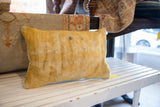 Textured side of the antique Chinese rug fragment pillow, with rich ochre pile and vintage patina.