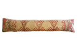 Vintage Oushak rug lumbar pillow with a beige ground and repeating red geometric motifs.
