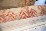 Textured vintage Oushak rug lumbar pillow with ivory pile and soft red geometric motif.