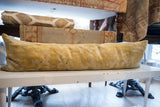 Elongated antique Chinese rug lumbar pillow, displaying its muted gold and soft-textured surface.