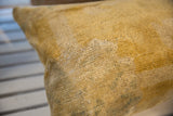 Close-up of the aged golden yellow pile on an antique Chinese rug fragment pillow.
