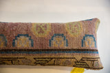 Vintage Khotan rug fragment lumbar pillow with muted geometric arch pattern and hand-knotted texture.