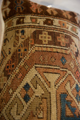 Geometric motifs and hand-knotted texture in earthy and indigo tones on this antique Caucasian pillow.