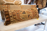 Brown, orange, and blue geometric pattern and weave on antique Caucasian pillow.