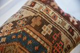 Hand-knotted weave of the antique Caucasian rug fragment, with geometric brown, beige, and rust patterns.