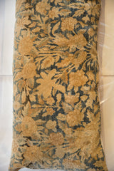 Golden and muted blue curvilinear motifs on the antique circa 1920s Kerman fragment pillow.