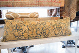 Golden floral motifs and deep blue ground on the antique Kerman rug pillow.