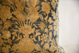 Antique Kerman pillow with intricate hand-knotted floral motifs in gold and deep blue.
