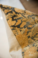 Textured gold and charcoal pile of antique Kerman fragment pillow, with cream linen side.