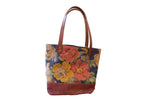 Vintage floral fabric market tote bag with blue, coral, yellow flowers and brown base.