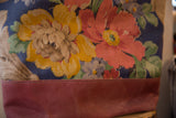 Market tote bag showing textured floral fabric meeting solid russet-toned canvas.