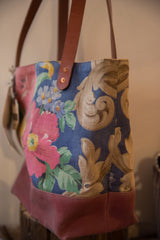 Brown leather strap with copper rivet on vintage blue and tan patterned tote.