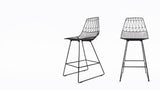 Two modern black wire Lucy Counter Stools, displaying side and front views.