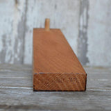 Walnut wood Peg and Awl stand with carved 'PEG AND AWL' logo on its side.