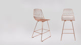 Copper wire frame legs with black foot caps on two Lucy Counter Stools.