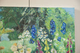 Vibrant blue, white, yellow, purple flowers amidst lush green foliage in a Grace B. Keogh painting.