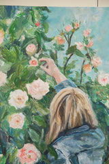 Painting detail of blonde hair, blue sleeve, and hand picking pale pink rose.