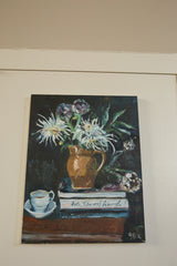 Angled view of Grace B. Keogh still life with white flowers, stacked books, teacup.