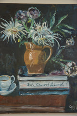 White teacup, stacked books, and artist's signature in the Keogh still life painting.