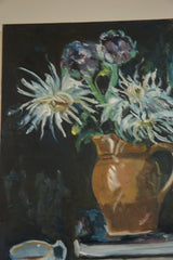 White teacup with blue interior on stacked books in Keogh's still life detail.
