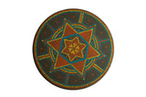 Matt Ulrich round wood painting, vibrant orange, yellow, and blue geometric Dutch dot pattern.