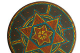 Close-up of Matt Ulrich painting, with vibrant orange, yellow, and blue Dutch dot patterns.
