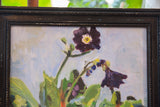 Close-up of the painting's upper right: deep purple flower, green leaves, distressed frame.