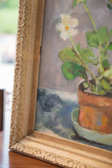 Cream ornate distressed frame of the Potted White Flowers painting, showing terra cotta pot.