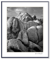 Black and white photograph of large, round rocks with textured surfaces in the Alabama Hills.