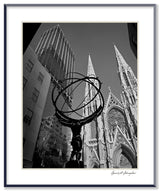 Black and white photograph of the Atlas statue with St. Patrick's Cathedral in New York City.