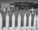Black and white photograph of the San Francisco Church landscape framed by a white picket fence.