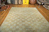 Vintage Oushak carpet, angled view with tone-on-tone repeating floral design in beige and greige.