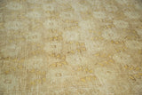 Vintage Oushak carpet's subtle repeating floral pattern in tone-on-tone beige, greige, and ivory.