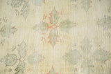 Blanched texture and faded angular clover motifs on this distressed Turkish Oushak rug.
