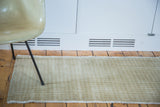 Tone-on-tone beige and silver ivory harlequin pattern on the vintage Oushak runner.